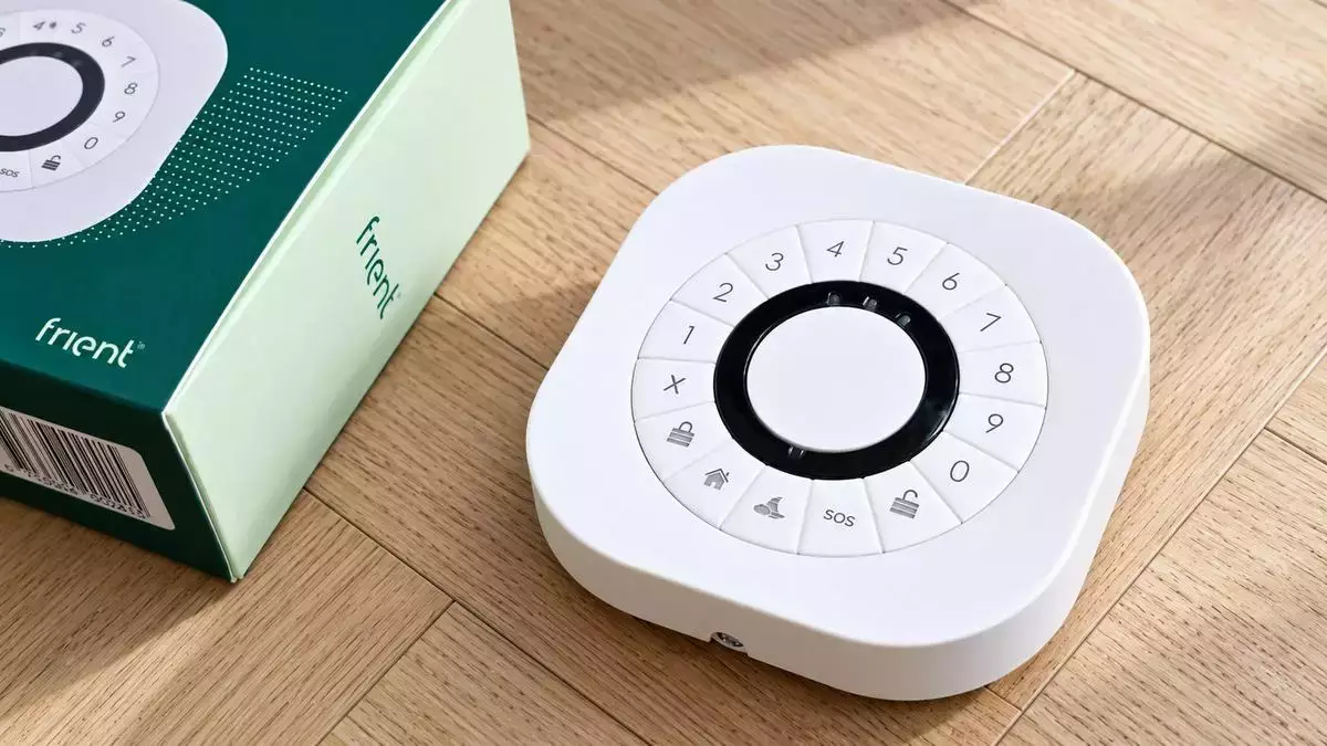 Clavier Zigbee frient présenté avec sa boîte sur un parquet en bois clair.